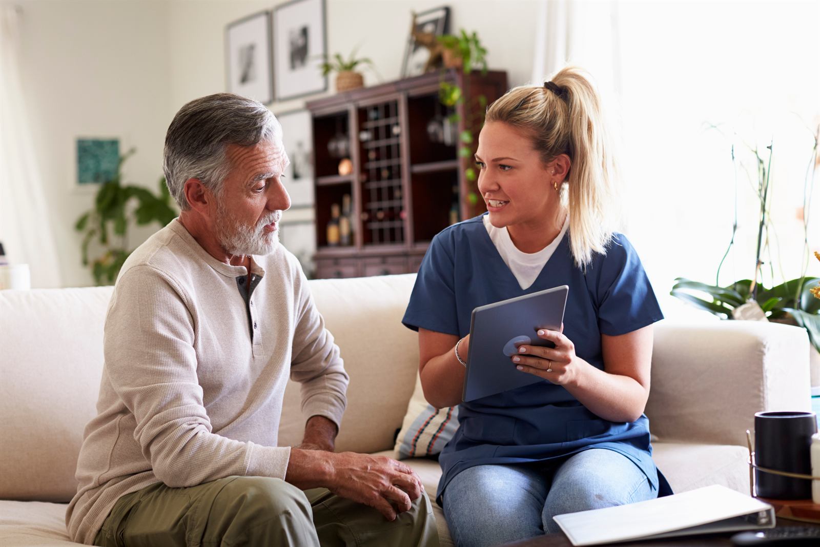 A Labs On Call phlebotomist reviewing details with a patient at home